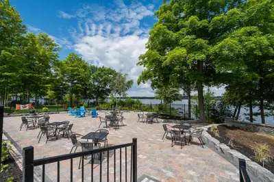 a group of tables and chairs on a brick patio at The Kiskadee - 49 Butternut in Cherry Valley