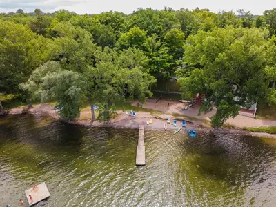 an aerial view of a body of water with a pier at The Kiskadee - 49 Butternut in Cherry Valley