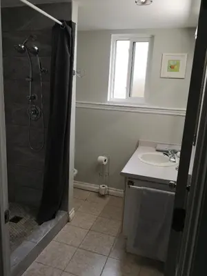 a bathroom with a shower and a sink at Cozy in London
