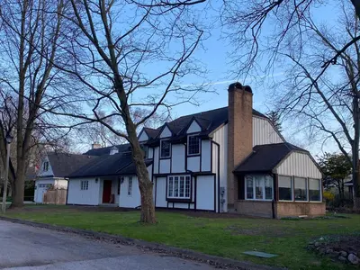 a white and black house with a chimney at Serenity on the Lake in Niagara on the Lake