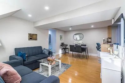 a living room with a couch and a table at Entire Basement Apartment in Toronto