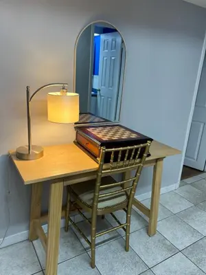 a dressing table with a chair and a mirror at Entire Basement Apartment in Toronto