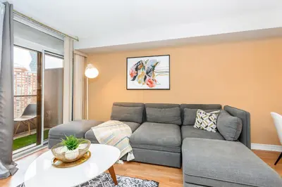 a living room with a couch and a table at High-End 2BR 2BATH Condo-Steps to Square One Mall in Mississauga