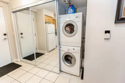 a laundry room with a washer and dryer at High-End 2BR 2BATH Condo-Steps to Square One Mall in Mississauga