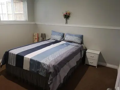 a bedroom with a bed and a vase of flowers at Cozy in London