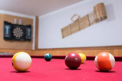 a billiard table with balls on top of it at Relax at The Mountaintop Chalet in Blue Mountains