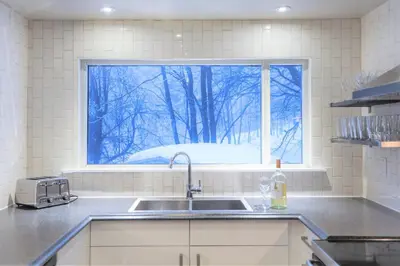 a kitchen with a sink and a window at Relax at The Mountaintop Chalet in Blue Mountains
