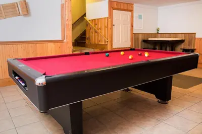 a pool table with red cover in a room at Relax at The Mountaintop Chalet in Blue Mountains