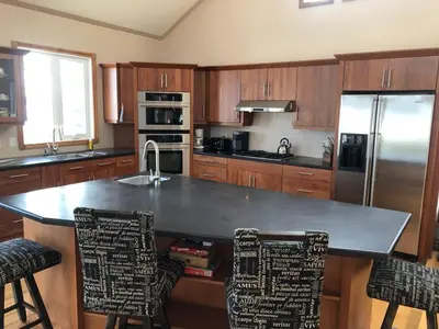 a kitchen with a counter with a sink and a refrigerator at Cottage apartments at Lake Huron in Midland