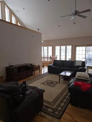 a living room with couches and a ceiling fan at Cottage apartments at Lake Huron in Midland