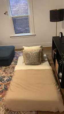 a large bed in a room with a window at 1BR Apartment Near Queen West in Toronto