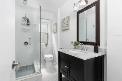 a bathroom with a sink and a shower and a toilet at 1BR Apartment Near Queen West in Toronto
