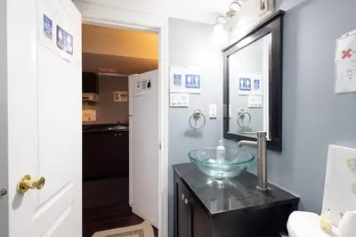 a bathroom with a bowl sink and a mirror at Affordable Private Suite, Near Airport, Free Parking in Mississauga