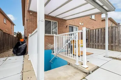 a white pergola on a porch of a house at Affordable Private Suite, Near Airport, Free Parking in Mississauga