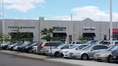 a parking lot with cars parked in front of a building at Affordable Private Suite, Near Airport, Free Parking in Mississauga