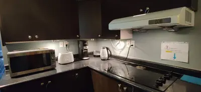 a kitchen with a counter top with a microwave at Affordable Private Suite, Near Airport, Free Parking in Mississauga
