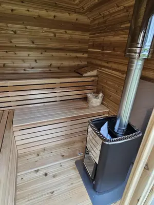 an inside of a sauna with a stove at The Hidden Pearl in Haliburton