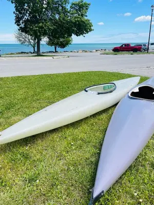 two surfboards sitting on the grass next to a street at Sunrise and Bayview with SNOW SHOES, WATERCRAFTS , BIKES in Meaford