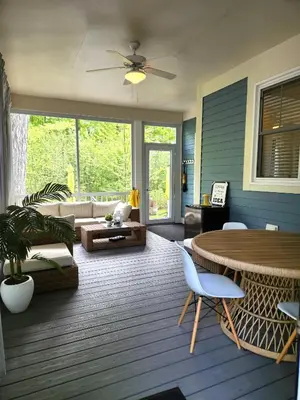 a living room with a table and a couch at L'Hibou - 18 Farm View in Cherry Valley
