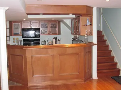 a kitchen with a bar with a microwave and a staircase at Large Guest suite with bathroom, vegetarian kitchen in Mississauga