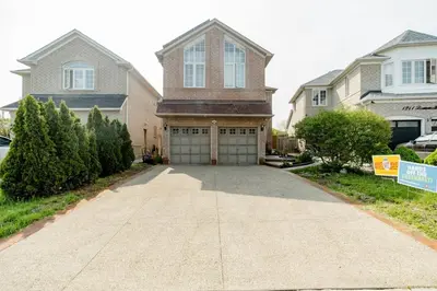 a house with a driveway with a garage at Large Guest suite with bathroom, vegetarian kitchen in Mississauga