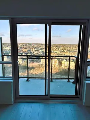 a room with a window with a view of a city at Stunning new condo in Oakville in Oakville