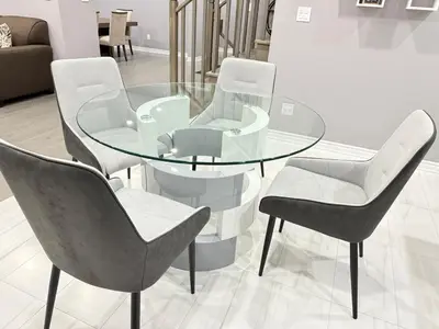 a glass table with four chairs and a glass table and chairs at 4-Bdrm Comfort with Fireplace mins from Downtown in Port Colborne