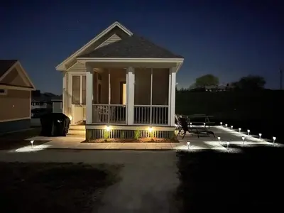 a house with a porch at night with lights at The Rushes - 47 Butternut in Cherry Valley