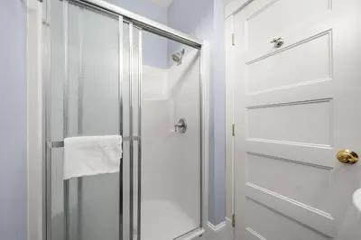 a shower with a glass door in a bathroom at The Cedar - 6 Hollow in Cherry Valley