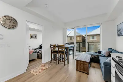 a living room with a couch and a table at Luxury Spacious Apartment 10 min to Airport Wifi in Brampton