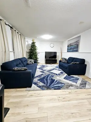 a living room with two couches and a christmas tree at 1 Bedroom Apartment with Living Room and Full Washroom to yourself alone and a private car park in London