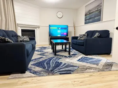 a living room with two couches and a tv at 1 Bedroom Apartment with Living Room and Full Washroom to yourself alone and a private car park in London