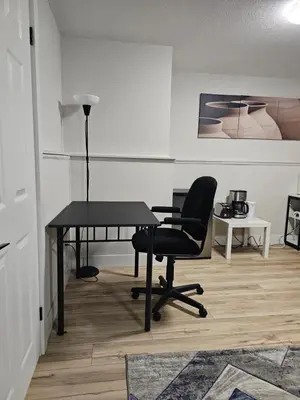 an office with a black desk and a chair at 1 Bedroom Apartment with Living Room and Full Washroom to yourself alone and a private car park in London