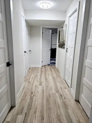 an empty hallway with white walls and wood floors at 1 Bedroom Apartment with Living Room and Full Washroom to yourself alone and a private car park in London
