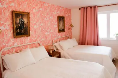 a bedroom with two beds and a painting on the wall at Comfy Waterfront Suite 2 Double Beds Ensuite in Belleville