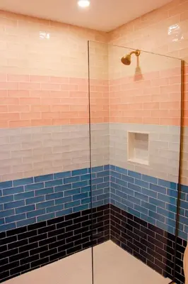 a bathroom with a shower with blue and white tiles at Comfy Waterfront Suite 2 Double Beds Ensuite in Belleville