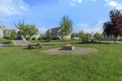 a park with a fire pit in the grass at 93 Butternut in Cherry Valley