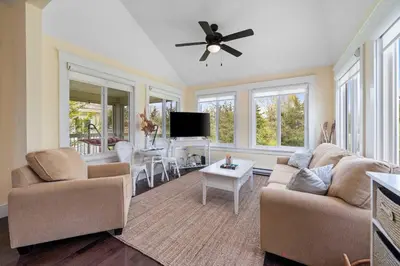 a living room with two couches and a flat screen tv at 93 Butternut in Cherry Valley