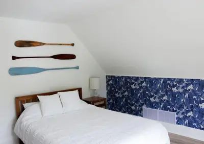 a bedroom with a bed and a painting on the wall at Guest Suite w Ensuite Waterfront in Belleville