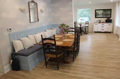 a dining room with a table and a couch at Guest Suite w Ensuite Waterfront in Belleville