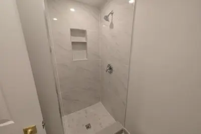 a bathroom with a shower with a glass door at Elegant & Stylish Apartments with Private Entrance & Parking in Richmond Hill