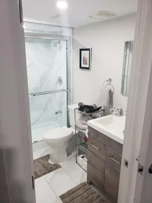 a bathroom with a shower and a toilet and a sink at Velohome - 3-Bed, 2-Bath Home in Milton