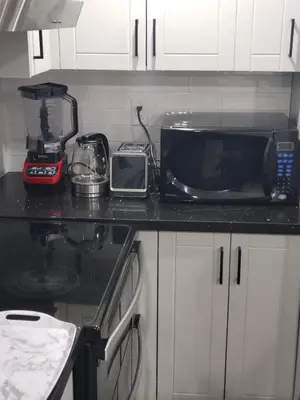 a kitchen counter with a microwave and a toaster at Velohome - 3-Bed, 2-Bath Home in Milton