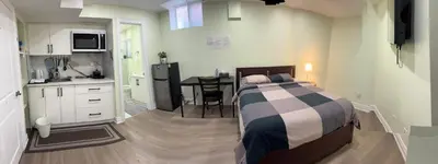 a bedroom with a bed and a kitchen with a table at B1 Beautiful and cozy private suite in Mississauga