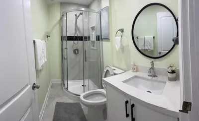 a bathroom with a shower and a toilet and a sink at B1 Beautiful and cozy private suite in Mississauga