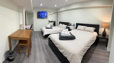 a room with two beds and a desk in it at B01 cozy private room with bathroom in Mississauga