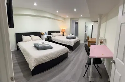 a bedroom with two beds and a pink desk at B01 cozy private room with bathroom in Mississauga