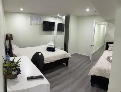 a hotel room with two beds and a table and a room at B02 luxurious suite in Mississauga