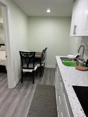 a kitchen with a table and a dining room at B02 luxurious suite in Mississauga
