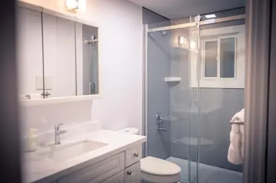 a bathroom with a shower and a sink and a toilet at Cozy Barrie Home - Minutes to College & Hospital in Barrie